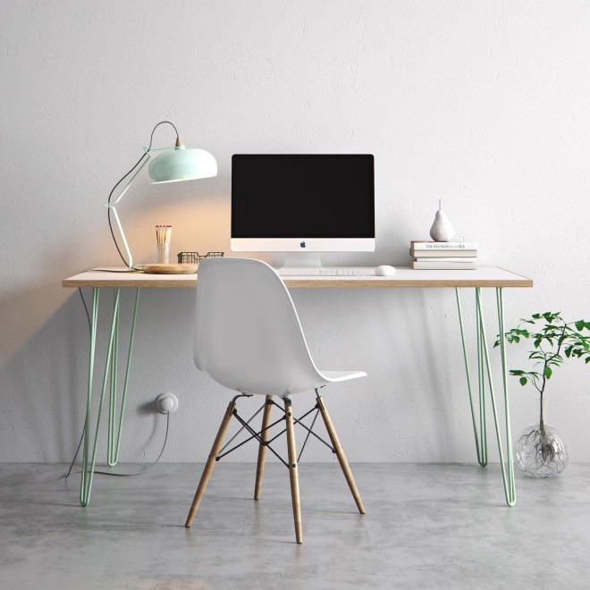 A white desk with mint green hairpin legs